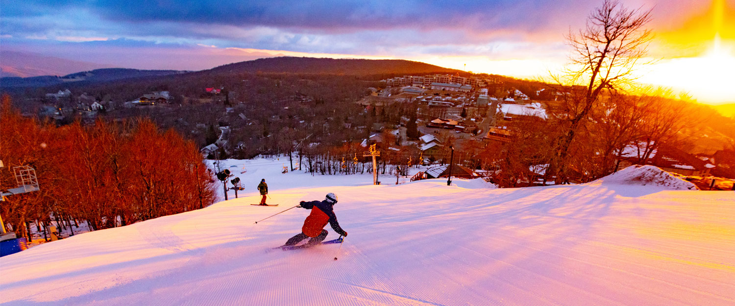 Skier on the Beech Mountain Resort's slopes at sunset.